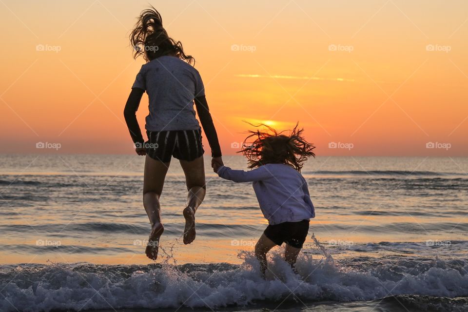 Two girls playing in the water at the beach