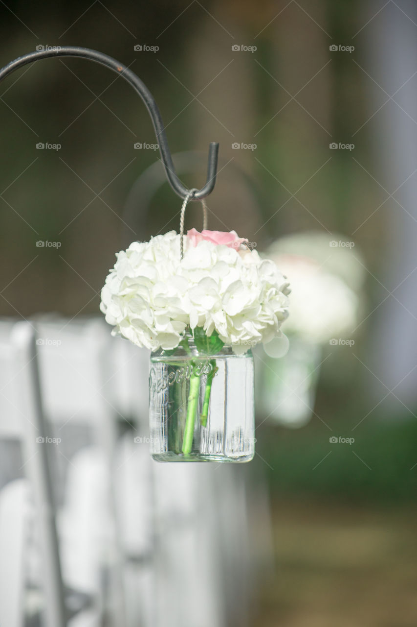 Hydrangea flowers in mason jars at wedding ceremony