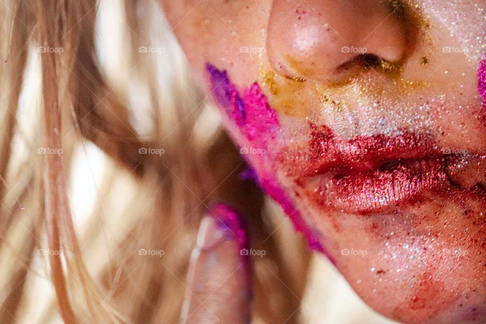 A child wearing glitter makeup