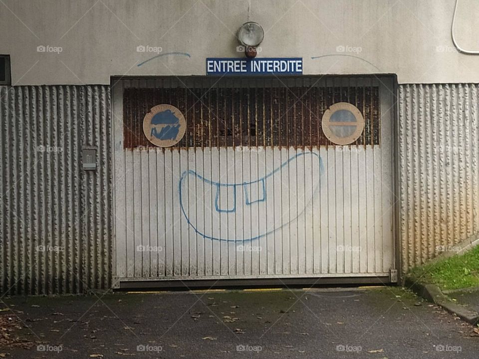 A character appears on a garage door