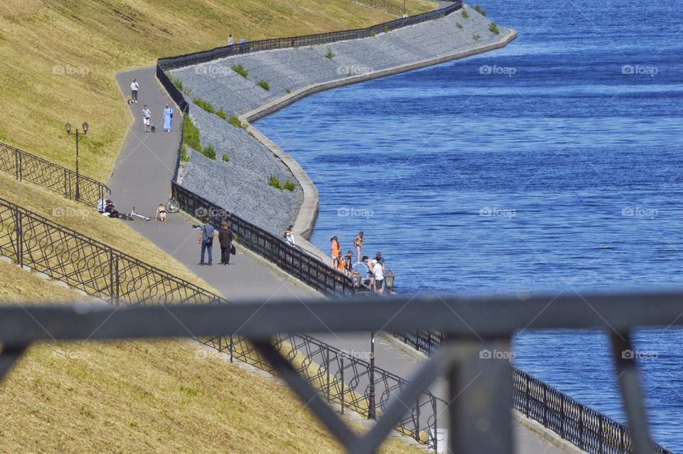 curved coastline where children bathe and old people take a walk