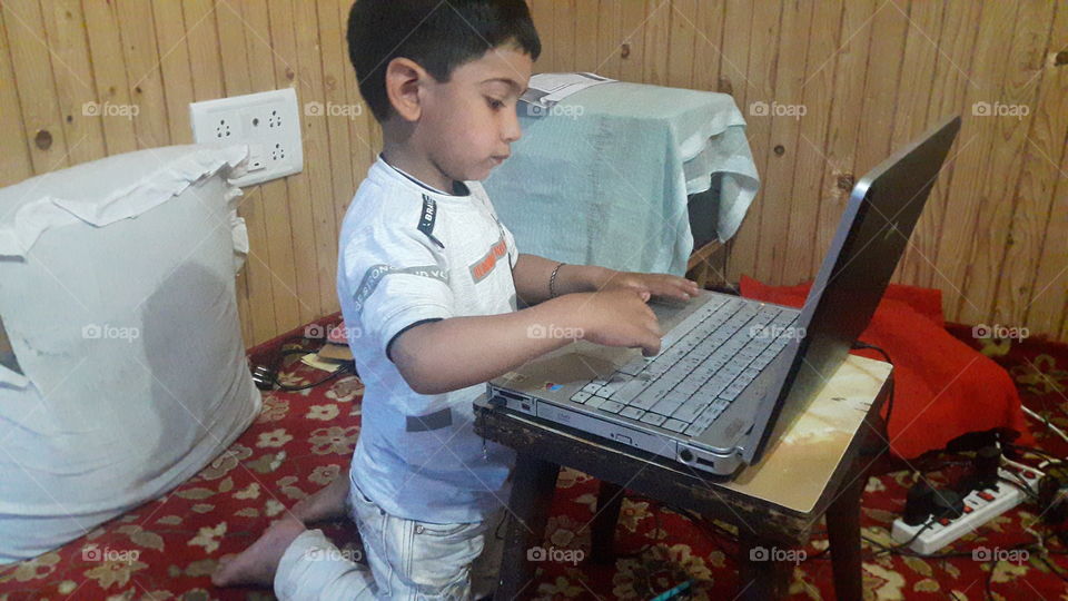 Getting acquited with Electronic Gadgets for his better Education ... 
My Lil  Surfing  on Lapitop