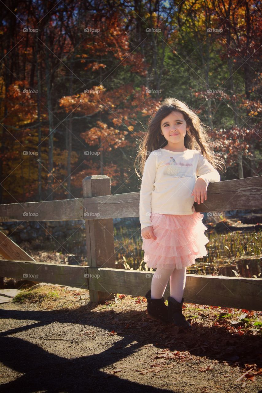 Girl standing near the fence