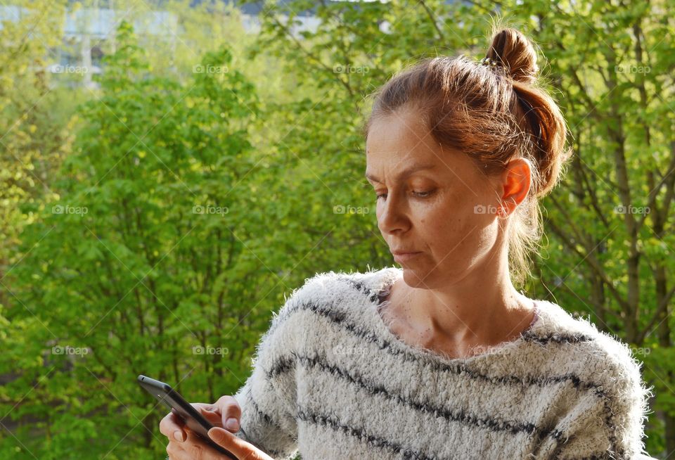 woman with phone green background