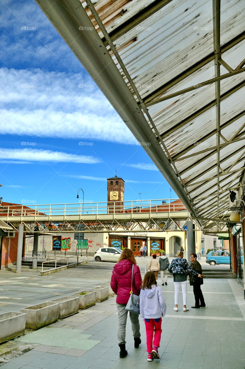 People strolling under a roofing