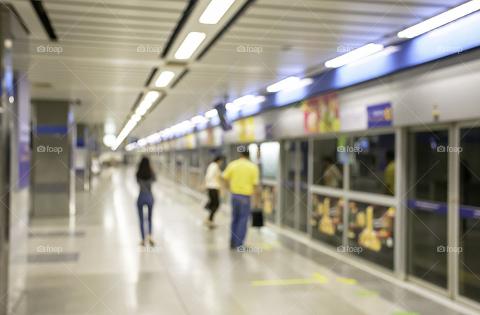 Blurry image of a passenger stand waiting for the subway