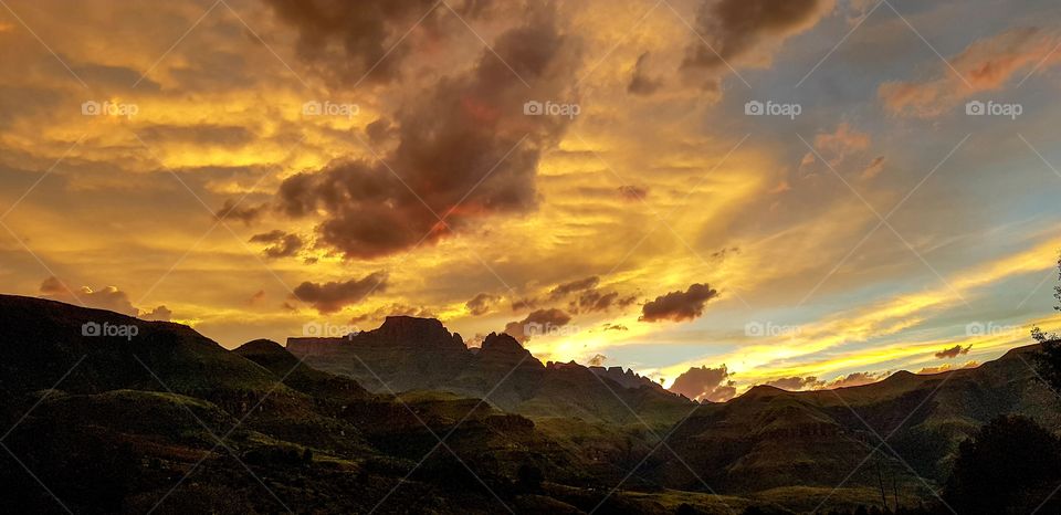 Dramatic skies as the sun sets over the Drakensberg Mountains in Kwazulu-Natal, South Africa