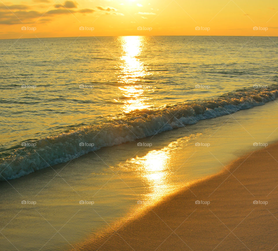 Scenic view of beautiful beach at sunset
