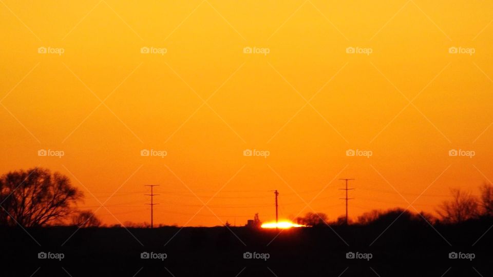 Sunset shot with the sun peeking over a hill