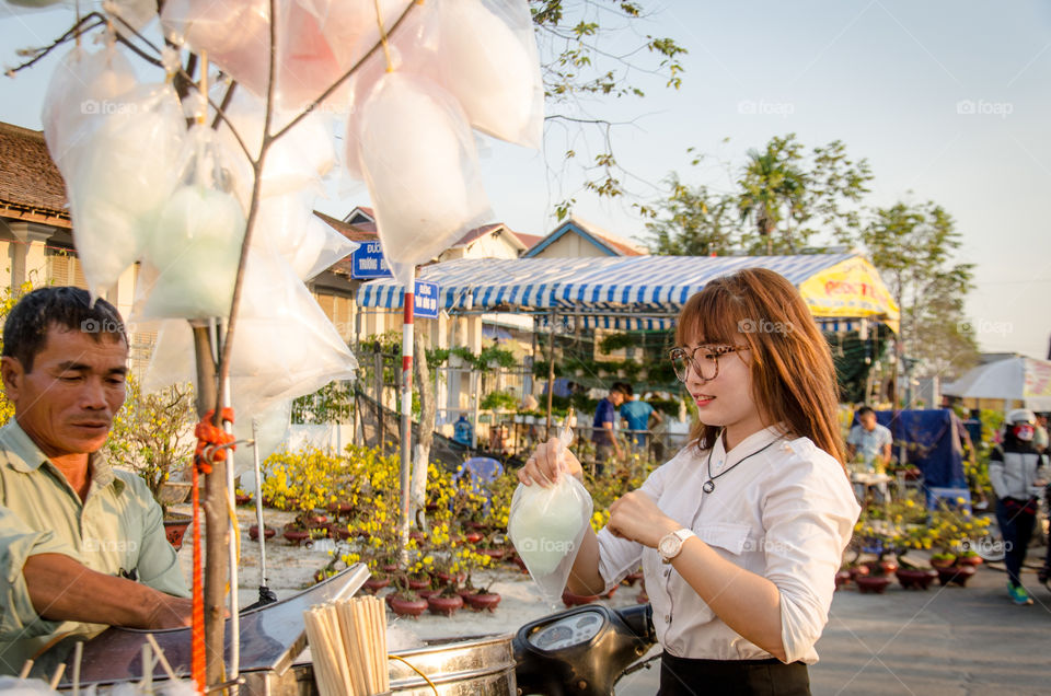 Man selling candy floss on street