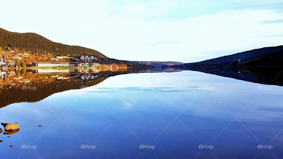 Mountain village, lake reflection