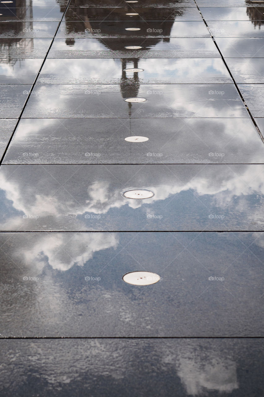 Reflection of the Bordeaux stock exchange on the water mirror place in Bordeaux, France 