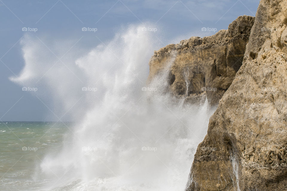 View of waves breaking on rocks