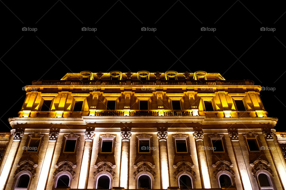 Low angle view of illuminated Buda Castle by night.