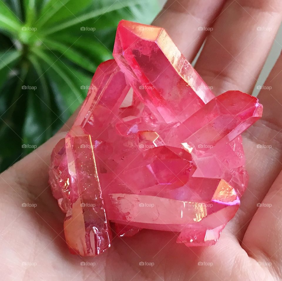 A pink aura quartz crystal cluster.