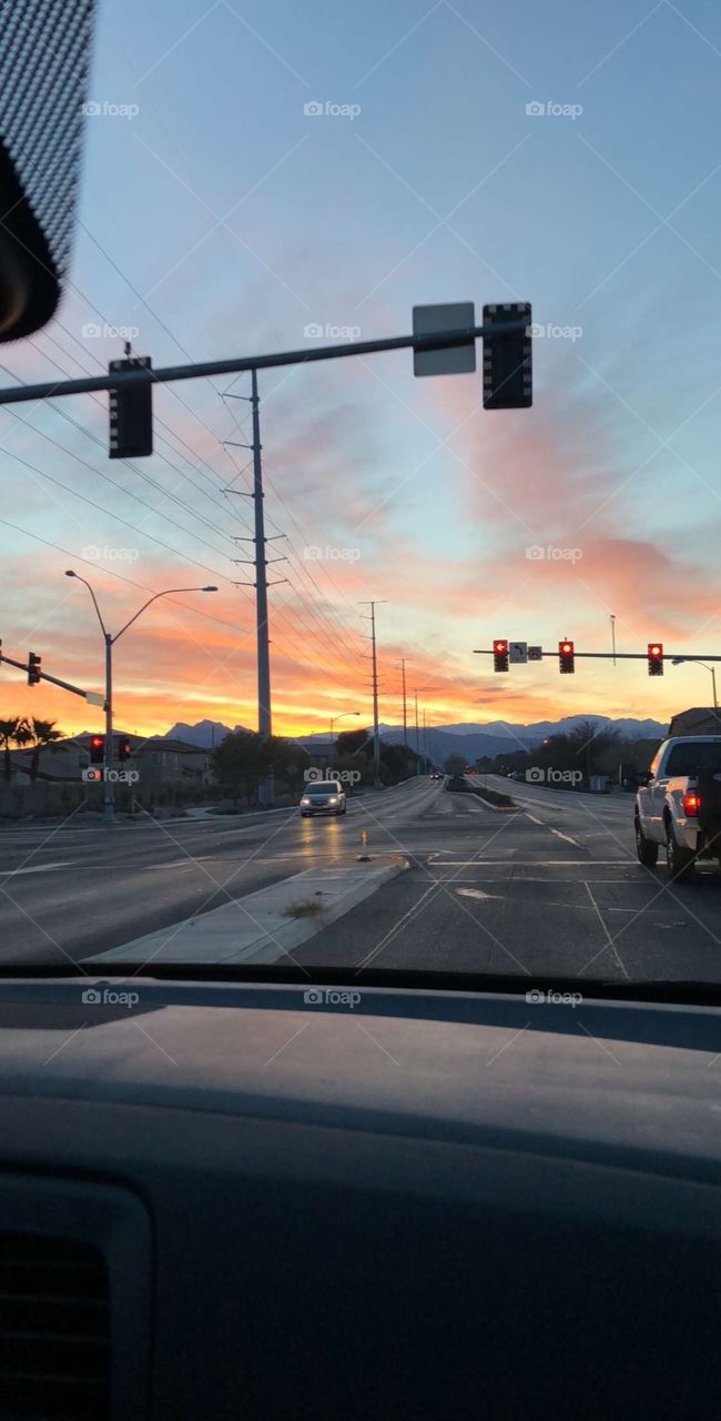 A beautiful sunset captured out on a drive in the city. 