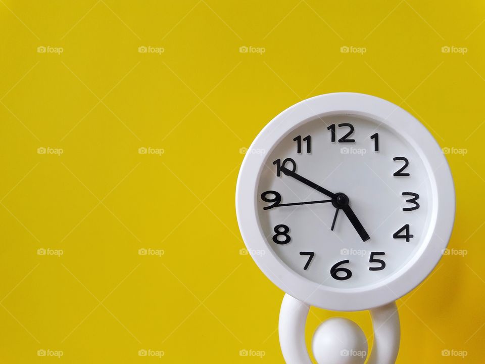 white clock with yellow background vintage
