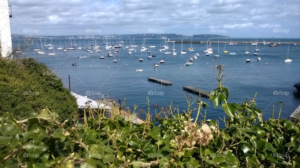 Brixham Harbour packer full with vessels of all shapes and sizes on a glorious day.
