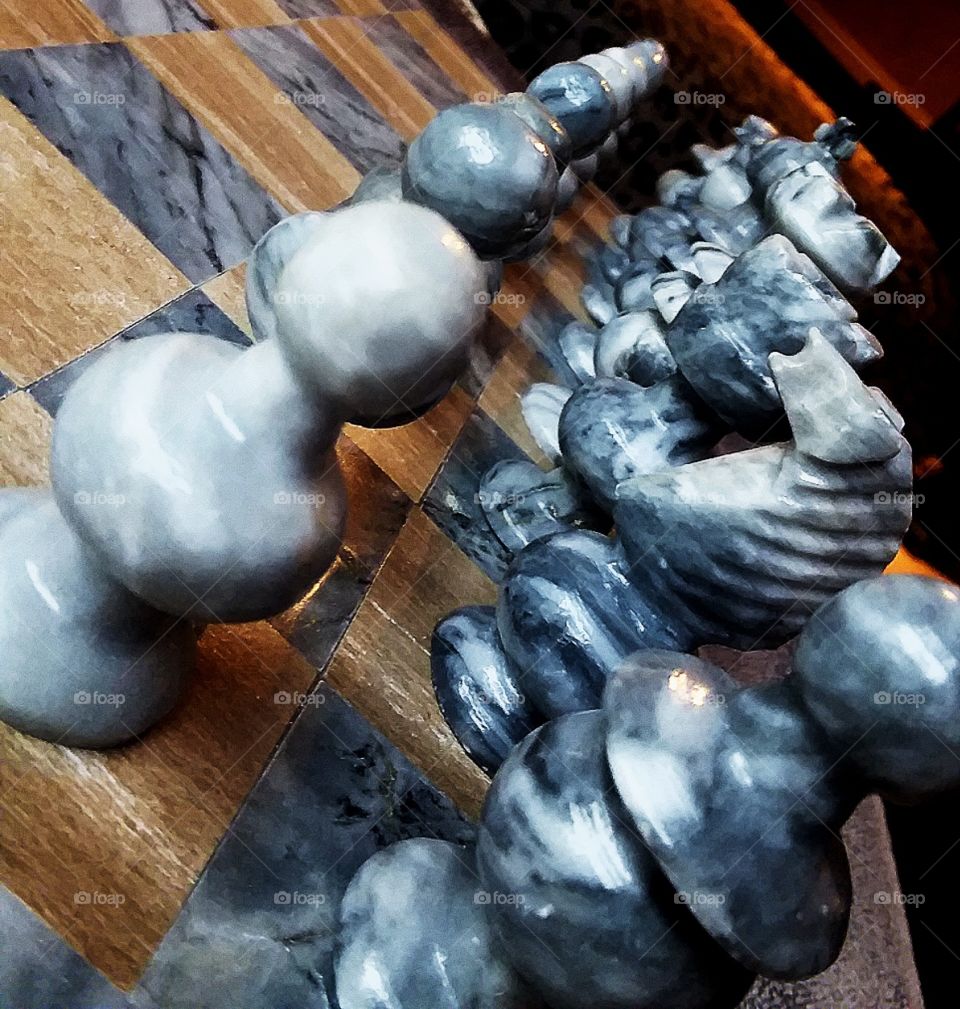 beautiful marble pieces set up on a chess board