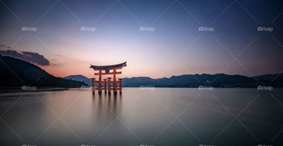 Torii gate at sunset on miyajima island