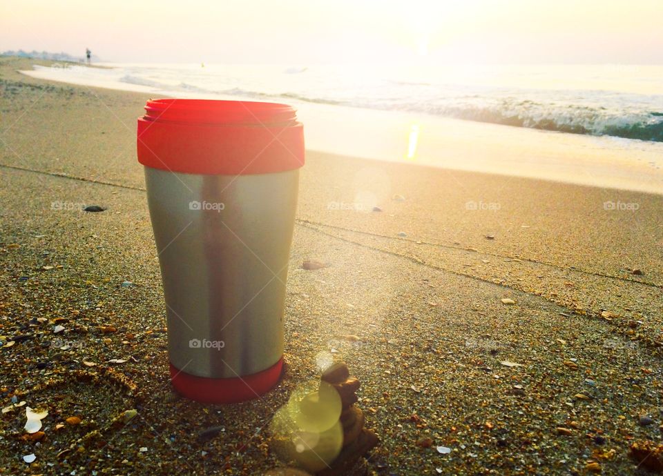 Red color story. Mug on a beach