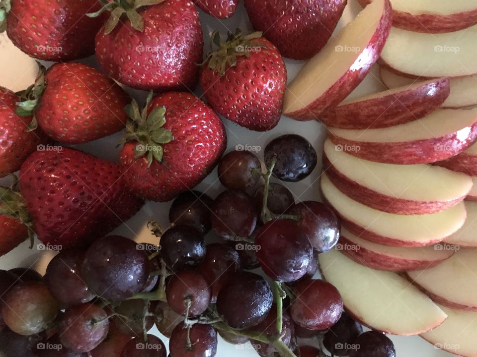 Fruit tray with grapes, strawberries, and apple slices