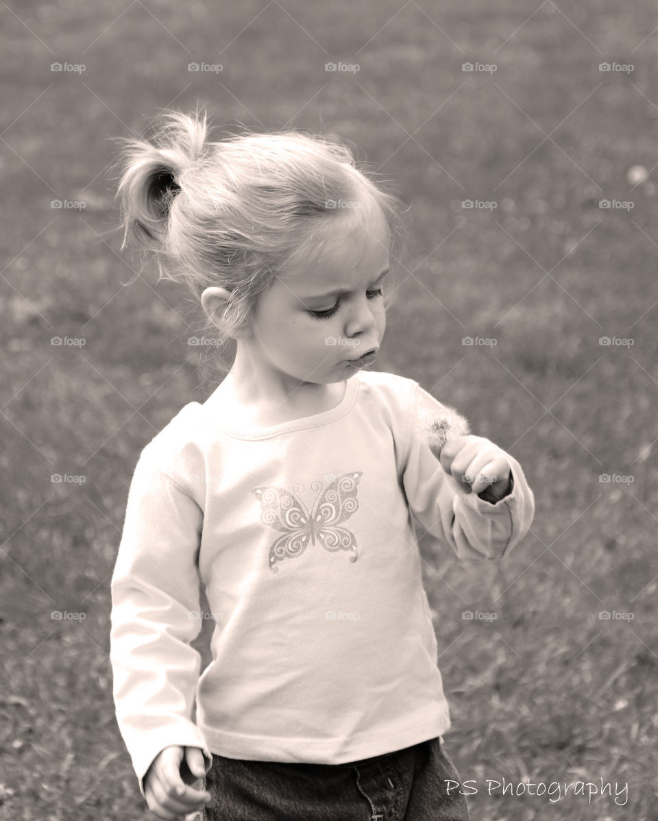 Girl holding dandelion flower