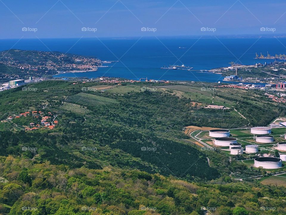 Scenic view of green hills against blue sky and Adriatic sea in Slovenia coast. Spring time