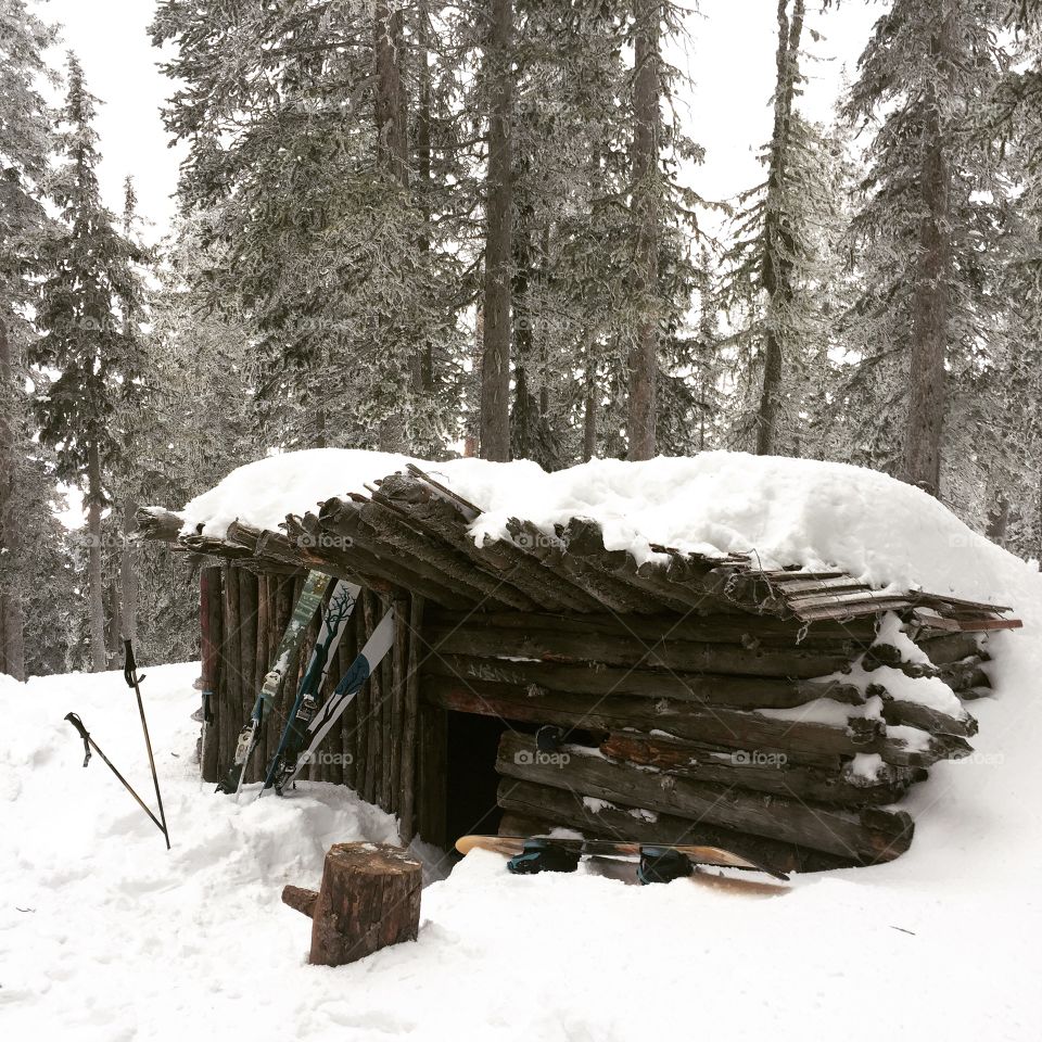Snow Cabin Under a Blanket of Snow
