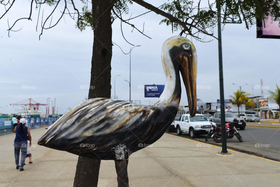 Fiberglass pelican in an avenue at the boat harbor