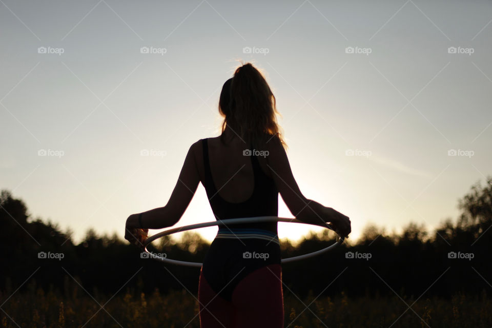hula hop girl at sunset
