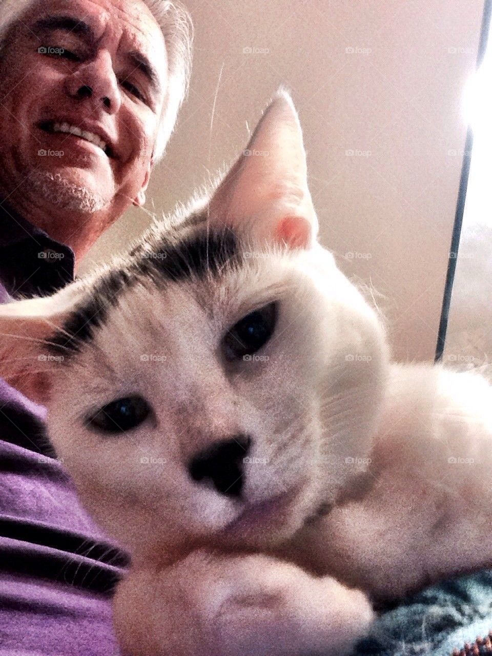 Man with cat smiling