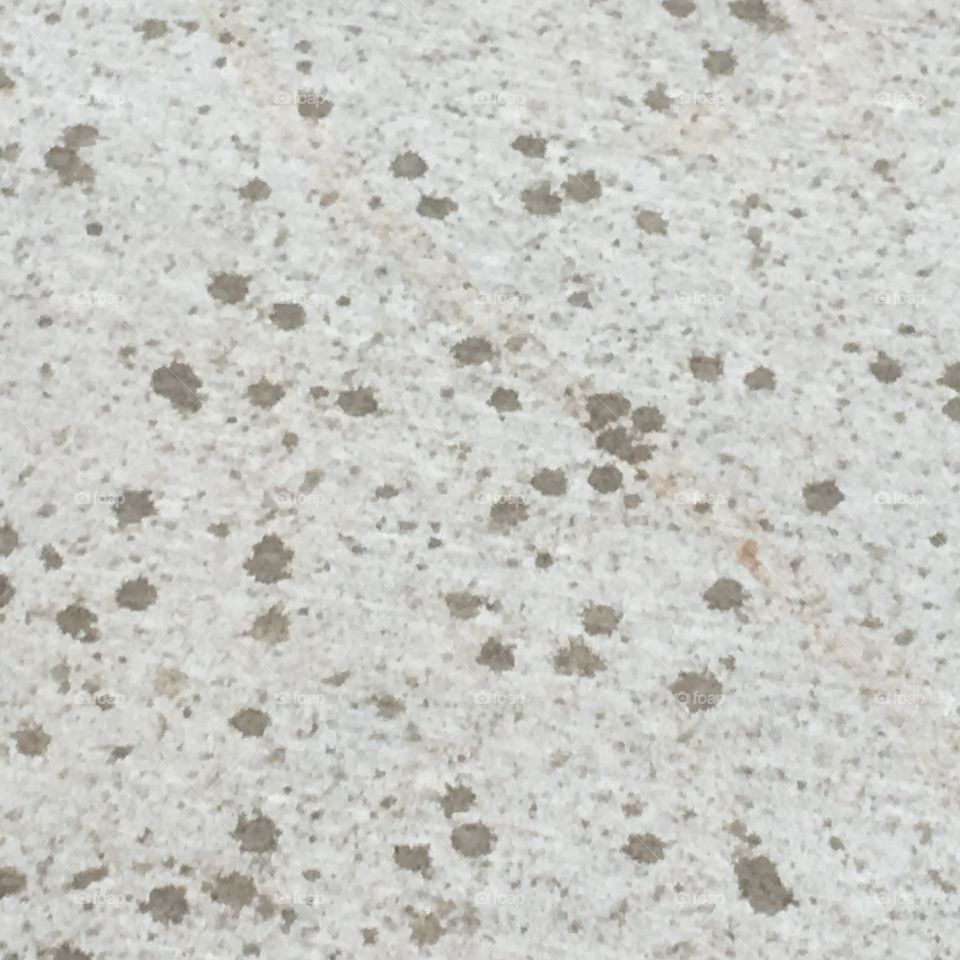 At bible study and it’s beginning to sprinkle rain drops on the concrete makes an interesting design 