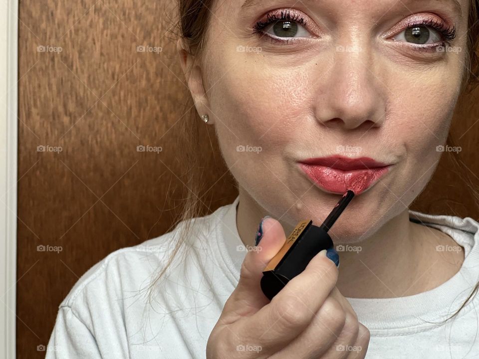 Putting on one of my favorite long-lasting L’ORÉAL liquid lip colors