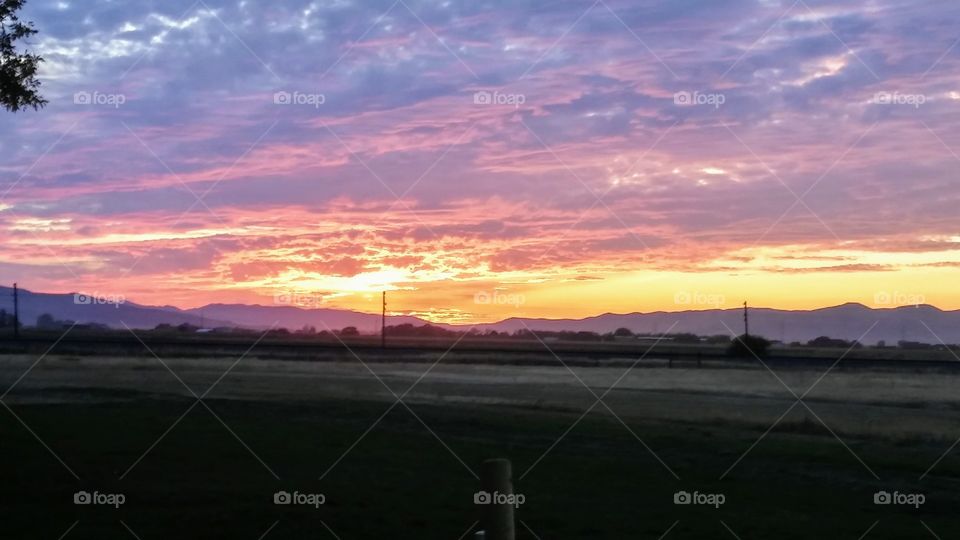 Sunset over a hot spring in Honeyville, Utah