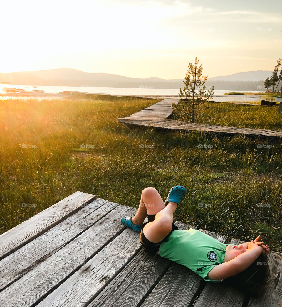 Relaxing in the sun’s glow next to the lake 
