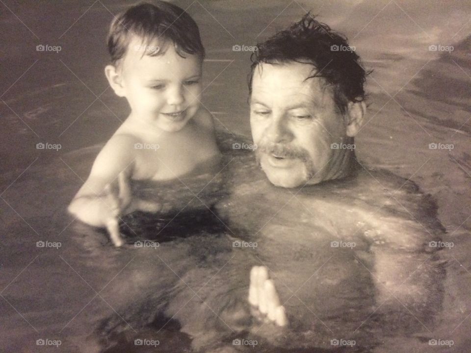 Man swimming with his grandson