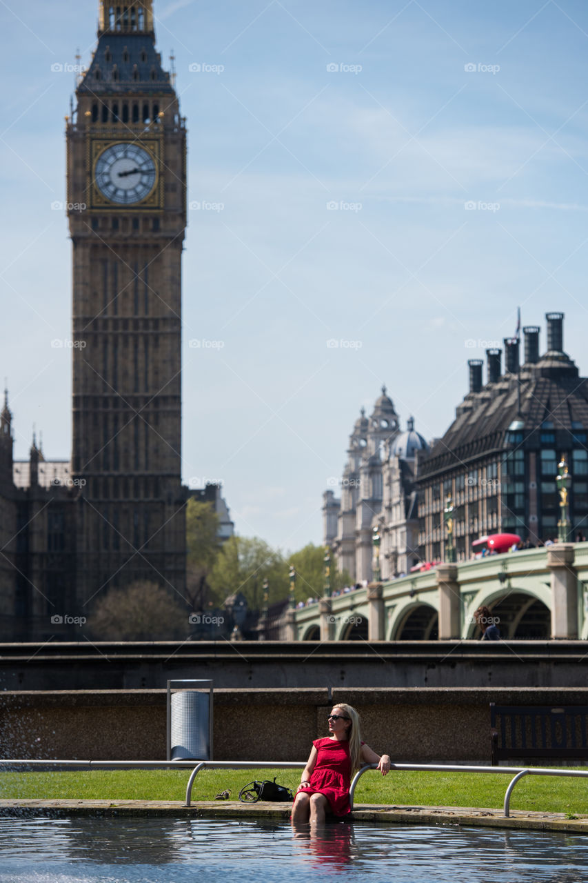 Woman sitting near water at big ben