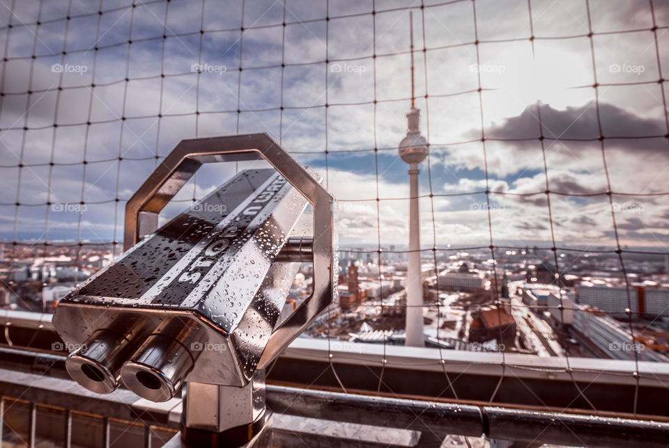 Binoculars telescope and panoramic view of Berlin city in Germany. Taken from the roof of the hotel Park Inn. View from above.