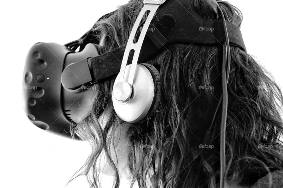 Black and white photo of a woman with virtual reality glasses and headset