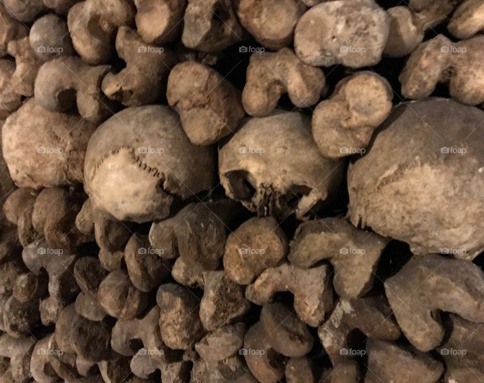 Skulls, and Various remains of unidentified residents - Des Catacombes in Paris, France.  