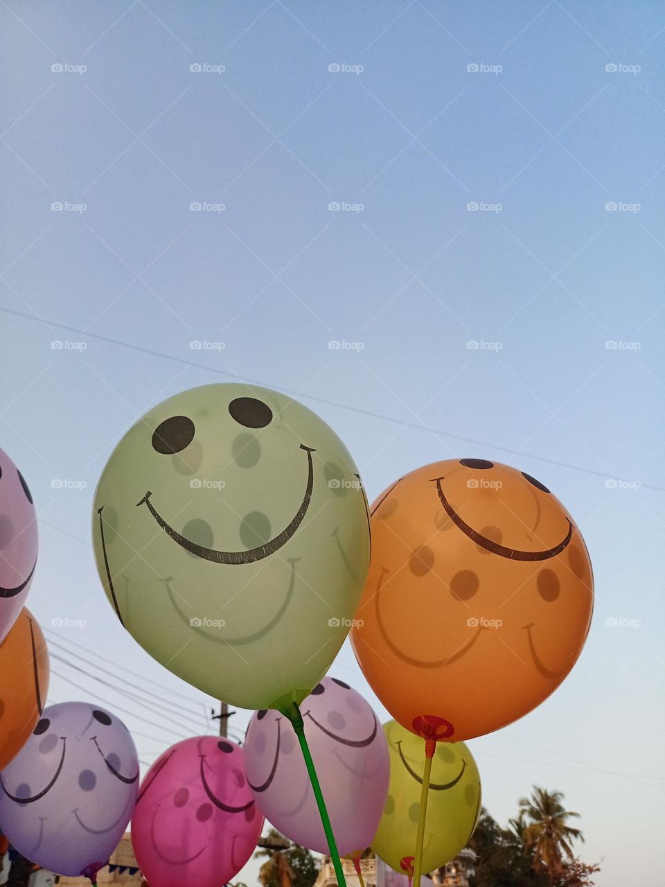 Beautiful colourful smiley face balloons with nice background of blue sky