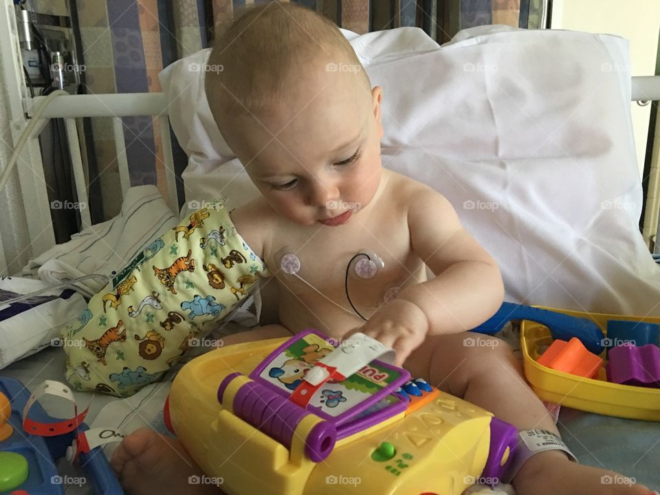Toddler boy in hospital with electrodes on chest