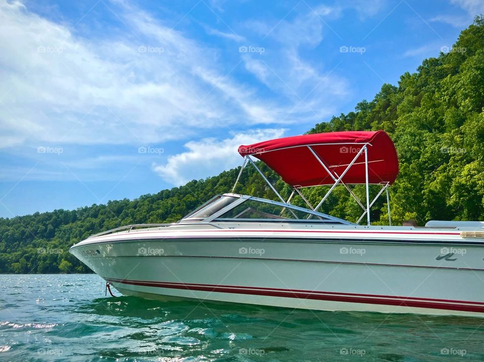 Beautiful white and red boat floating on the Lake on a hot summer day