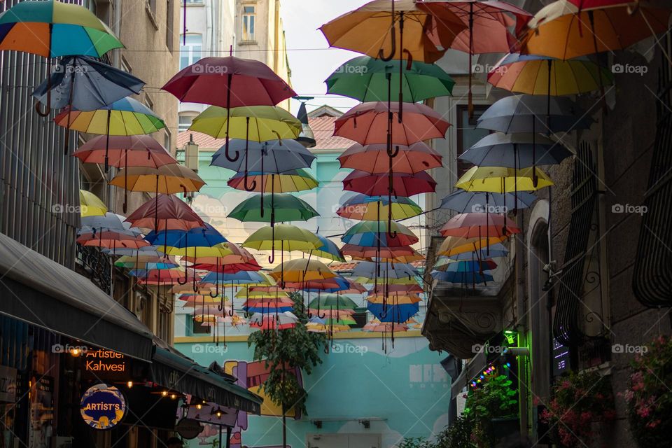 Umbrellas with pride colours hung on the street