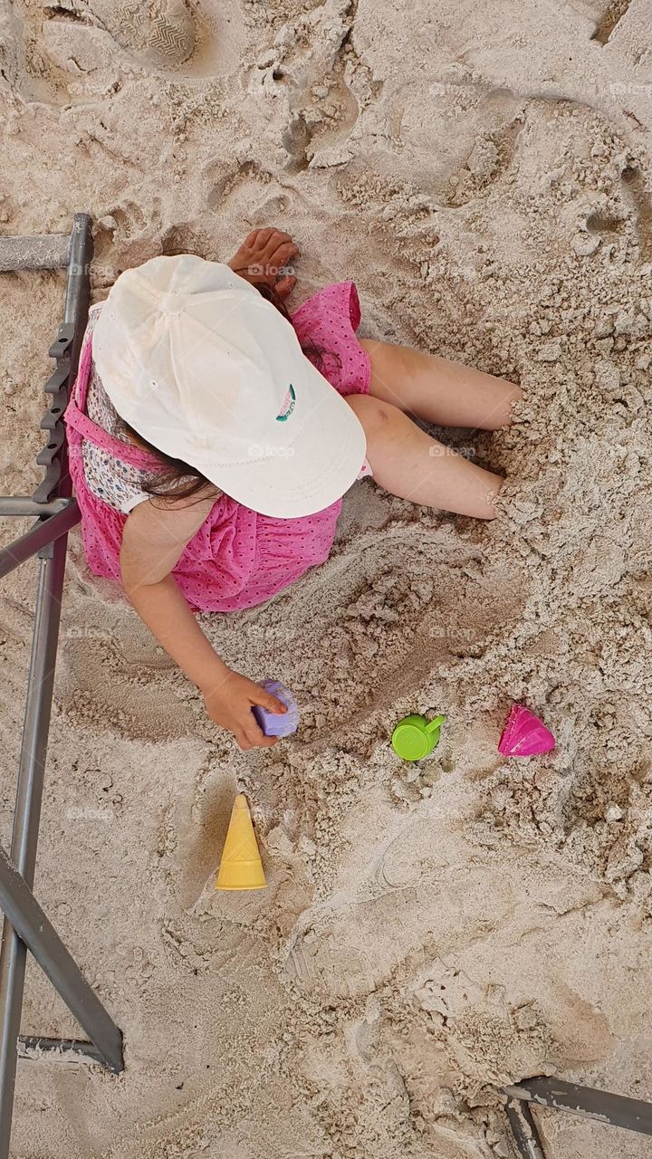 daughter playing on the sand