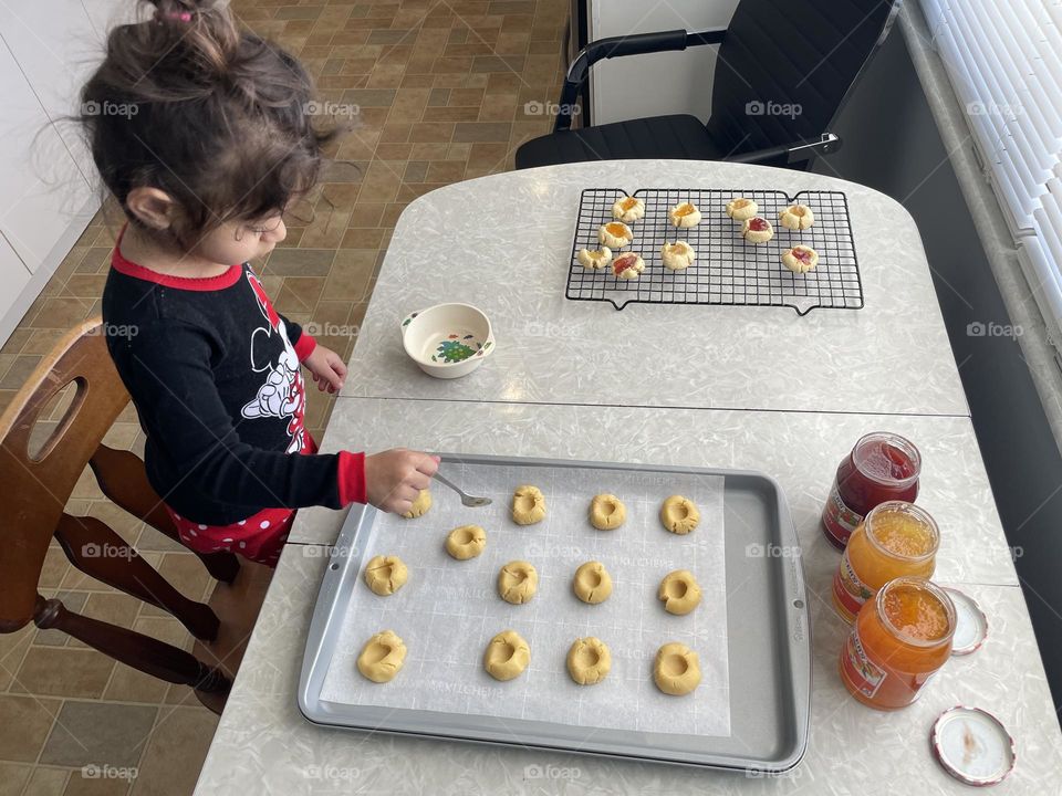 Making thumbprint cookies with a toddler on Christmas, making holiday cookies with kids, thumbprint cookies filled with jelly, baking for the holidays, baking in the kitchen with kids, making treats for the family, toddler helping in the kitchen 