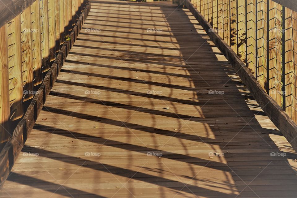 Shadows falling on the boardwalk,  lovely night for a walk.