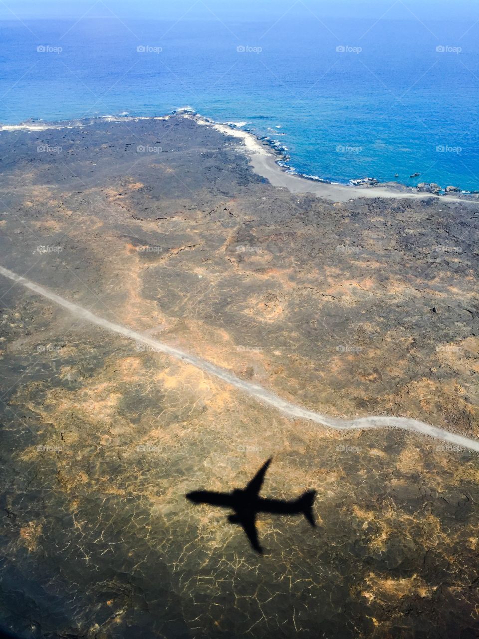 Airplane shadow on the lava rock.  On the Big Island of Hawaii'.