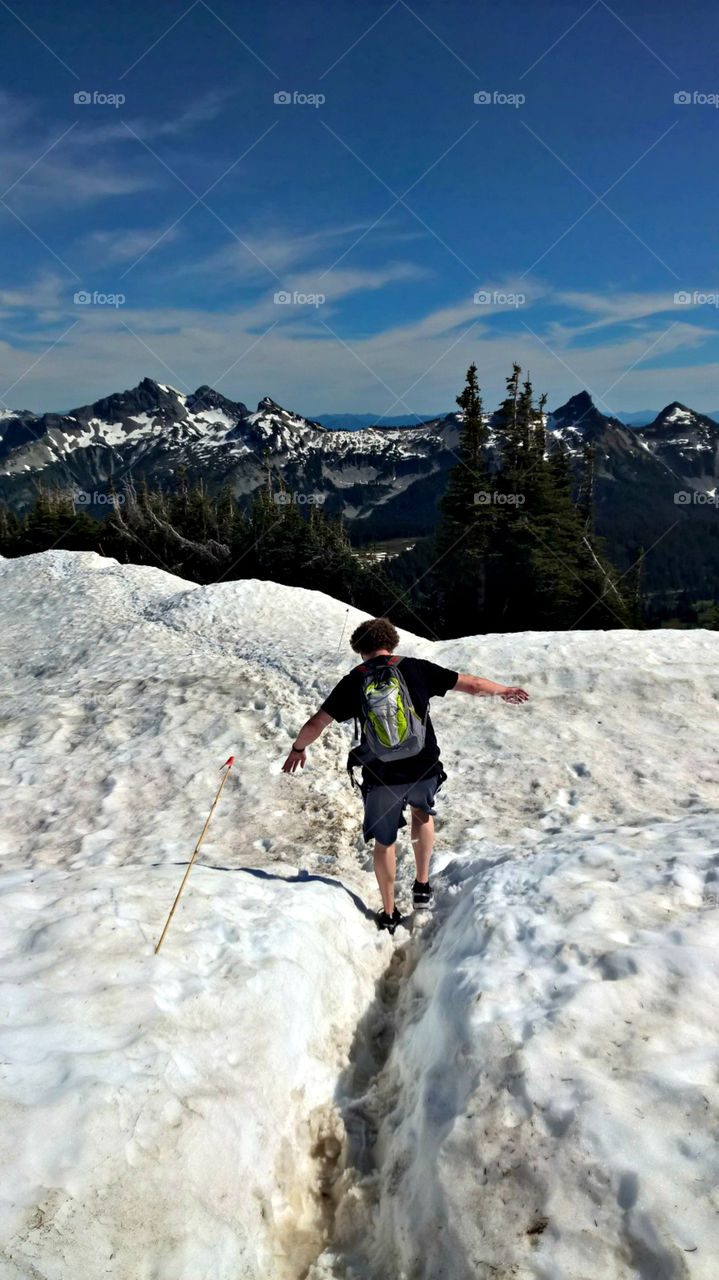 Man Hiking in snow covered trail. Mt. Rainier, WA June 2015